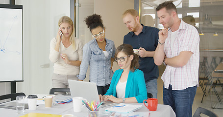 Image showing Woman with coworkers watching laptop