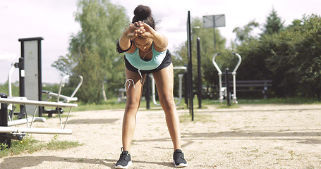 Image showing Sportswoman warming up in park