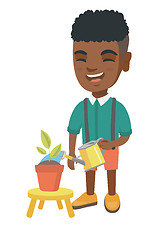 Image showing African boy watering plant with a watering can.