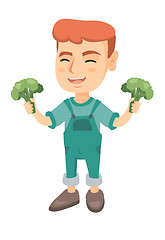 Image showing Little caucasian boy laughing and holding broccoli