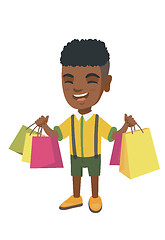 Image showing Happy african-american boy holding shopping bags.