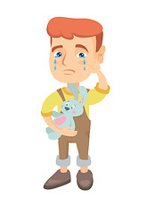 Image showing Caucasian boy crying and holding toy.