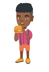 Image showing Little african-american boy eating a hamburger.