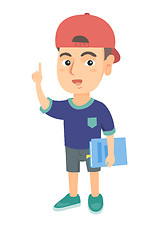 Image showing Little caucasian schoolboy pointing forefinger up.