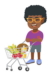 Image showing Little african boy with his shopping trolley.