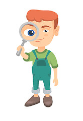 Image showing Caucasian boy looking through a magnifying glass.