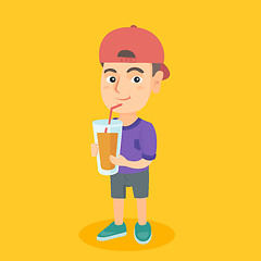 Image showing Boy drinking orange juice through a straw.