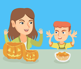 Image showing Mother and son carving pumpkins for Halloween.