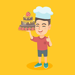 Image showing Caucasian child in chef hat holding a cake.