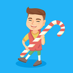 Image showing Caucasian little boy holding christmas candy cane.