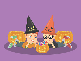 Image showing Caucasian boys staring at the pumpkin with candies