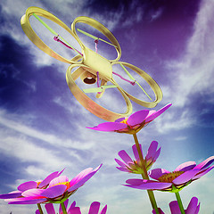 Image showing Drone, quadrocopter, with photo camera against the sky and Beaut