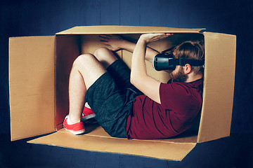 Image showing Introvert concept. The man sitting inside box with glasses of virtual reality. Future technology concept