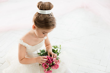 Image showing The little balerina in white tutu in class at the ballet school