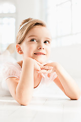 Image showing The little balerina in white tutu in class at the ballet school