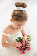 Image showing The little balerina in white tutu in class at the ballet school