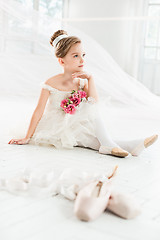 Image showing The little balerina in white tutu in class at the ballet school