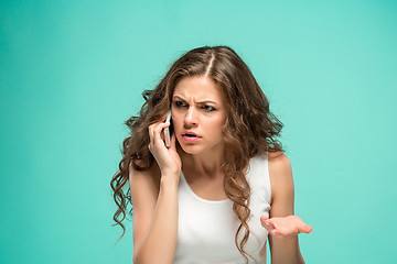 Image showing The portrait of disgusted woman with mobile phone