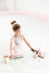 Image showing The little balerina in white tutu in class at the ballet school