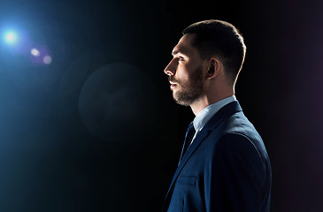 Image showing businessman over black background with lens flare