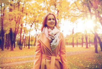 Image showing beautiful happy young woman walking in autumn park