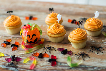 Image showing halloween party decorated cupcakes on wooden table