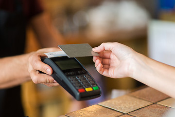 Image showing hands with payment terminal and credit card