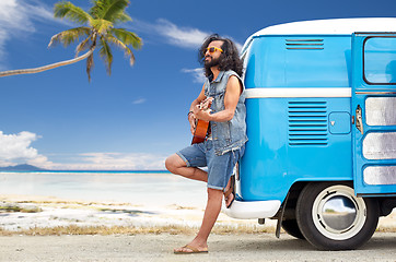 Image showing hippie man playing guitar at minivan car on beach