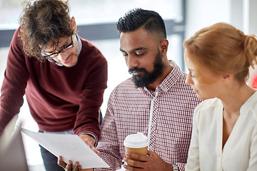 Image showing business team with papers and coffee at office