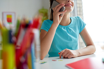 Image showing close up of girl calling on smartphone at home