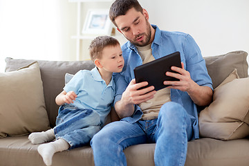 Image showing father and son with tablet pc playing at home