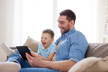 Image showing father and son with tablet pc playing at home