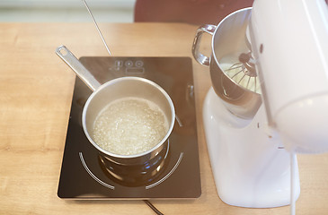 Image showing electric mixer and pot on stove at kitchen