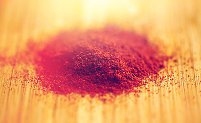 Image showing cayenne pepper or paprika powder on wood