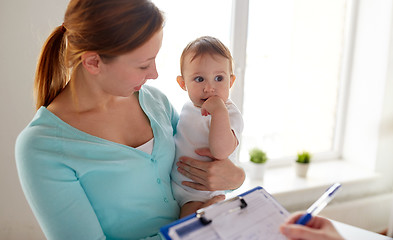 Image showing happy woman with baby and doctor at clinic