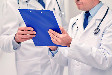 Image showing close up of doctors with clipboard at hospital