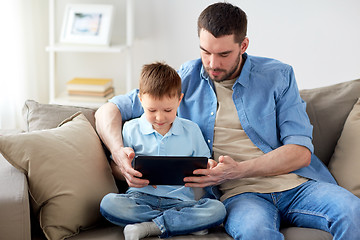 Image showing father and son with tablet pc playing at home