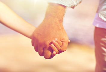 Image showing senior man and child holding hands