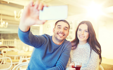 Image showing couple taking smartphone selfie at cafe restaurant