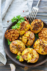 Image showing Potatoes baked with garlic,thyme and green parsley.