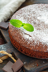 Image showing Chocolate cake sprinkled with powdered sugar.