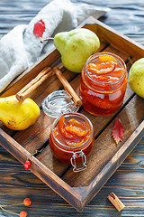 Image showing Jam from pears in glass jars and fresh pear.