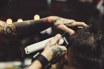 Image showing Barber shaving man in chair