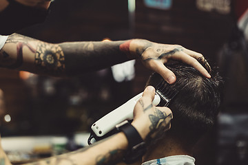 Image showing Barber shaving man in chair