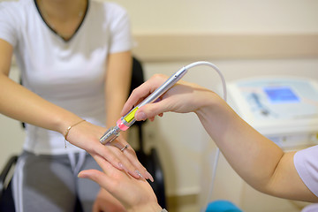 Image showing Young woman receiving laser therapy