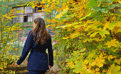 Image showing Teen girl in the autumn forest and hut