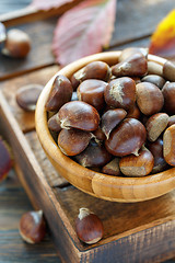 Image showing Ripe chestnuts in a wooden bowl.