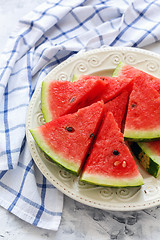 Image showing Juicy watermelon sliced on a white porcelain dish.