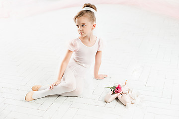 Image showing The little balerina in white tutu in class at the ballet school