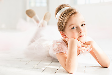 Image showing The little balerina in white tutu in class at the ballet school